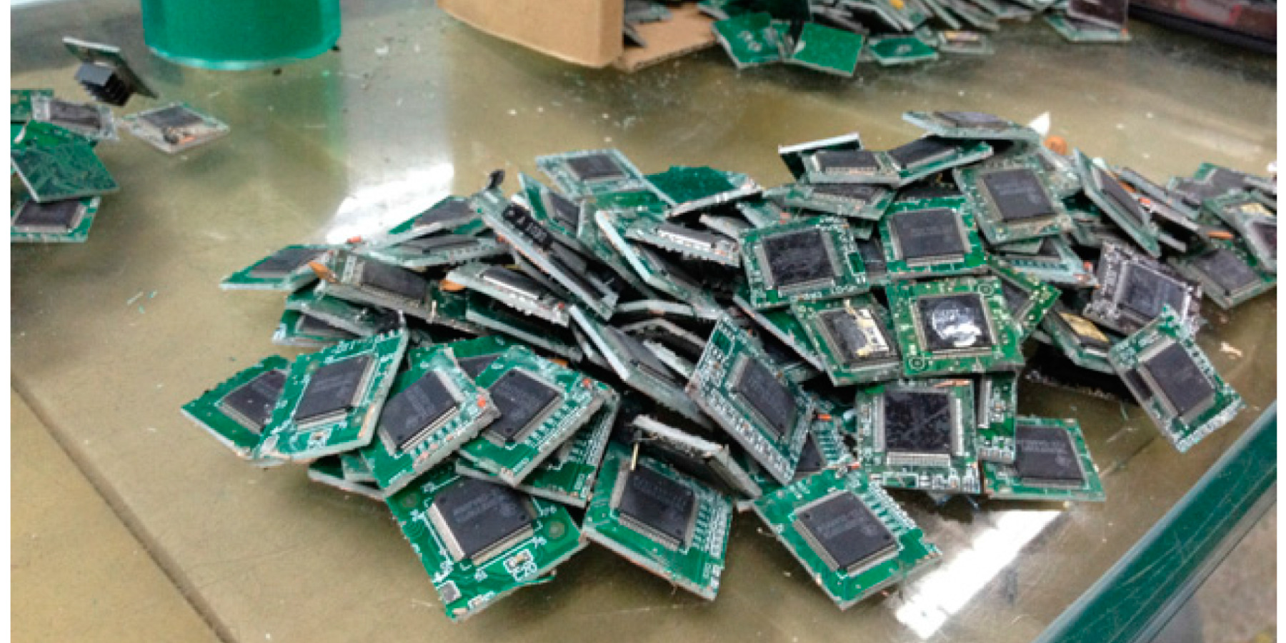 Pile of recovered chip modules on a workbench
