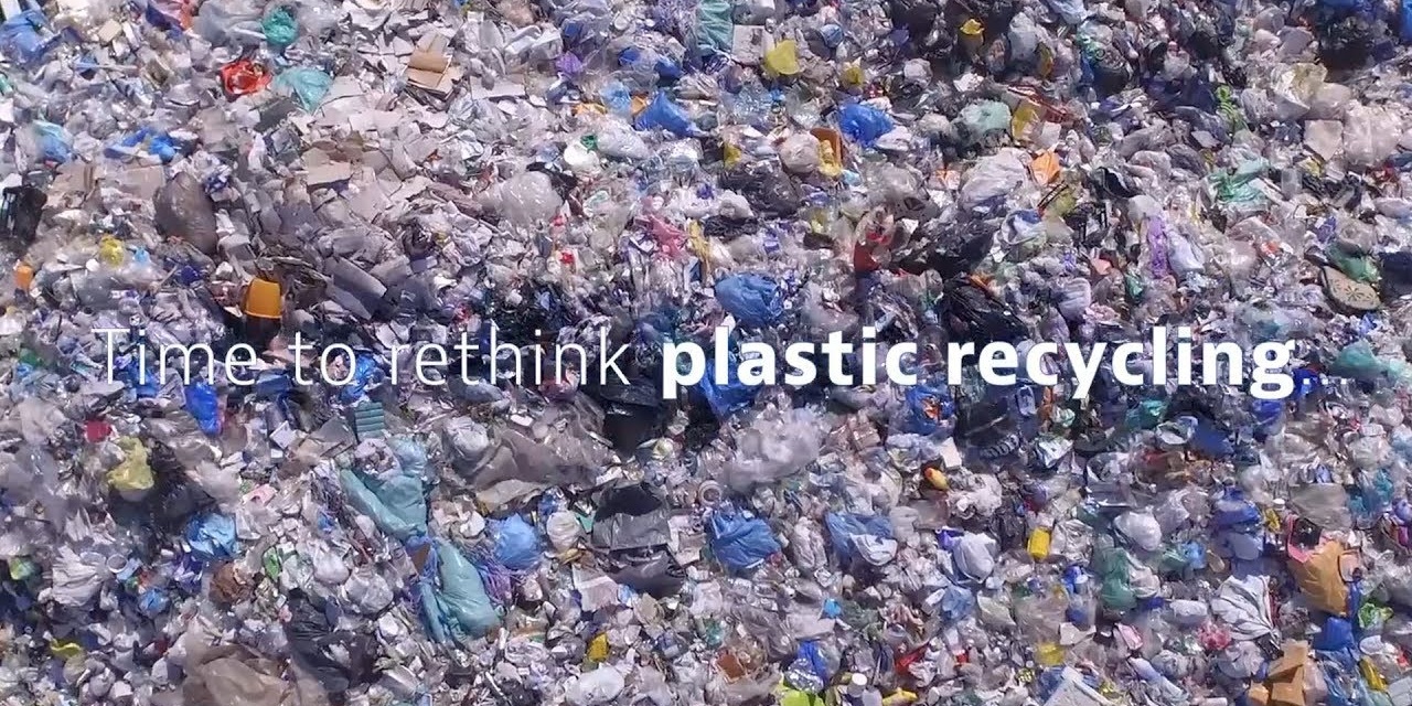 Mixed shredded plastic flake with the caption time to rethink plastic recycling